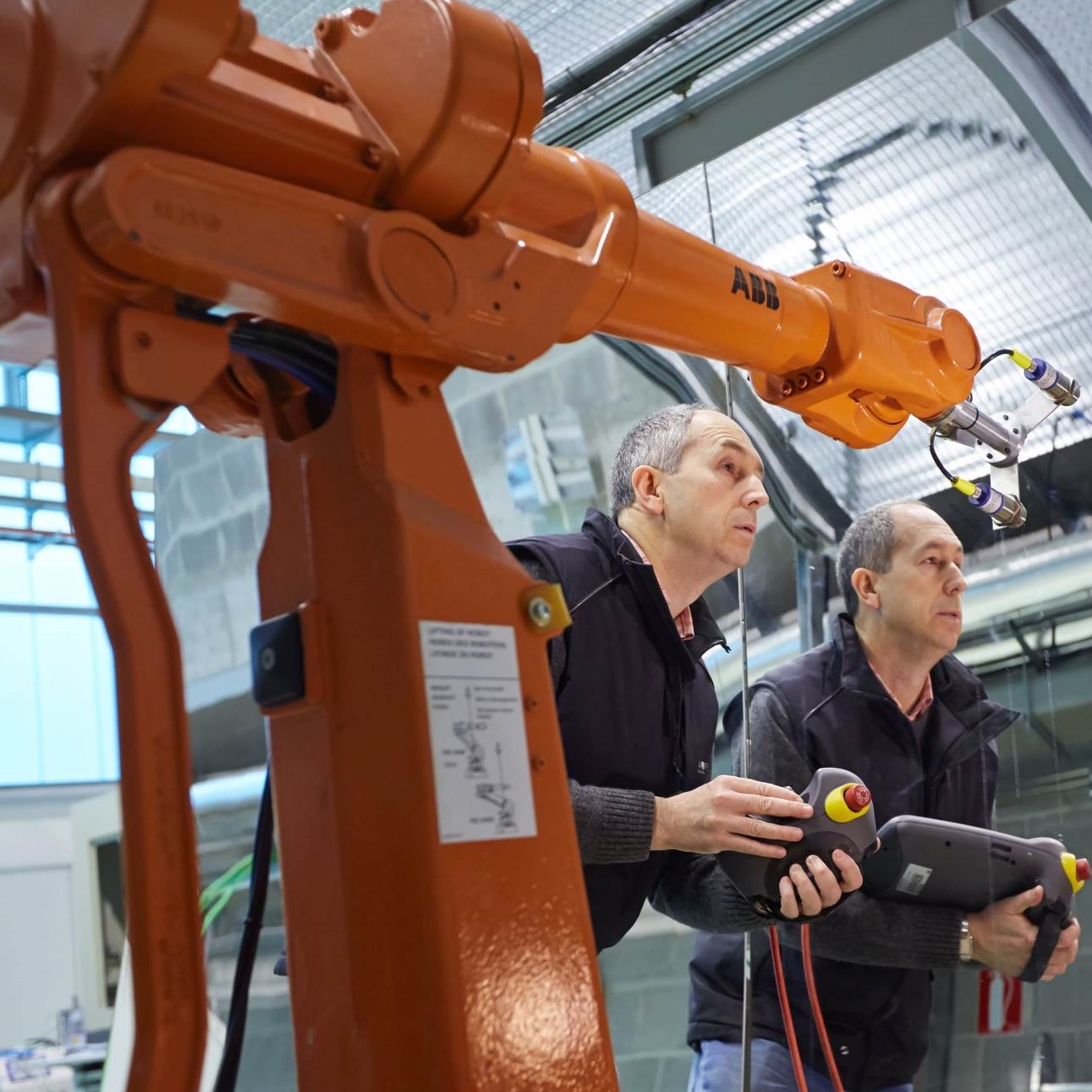 Technicians setting up an ABB industrial robot